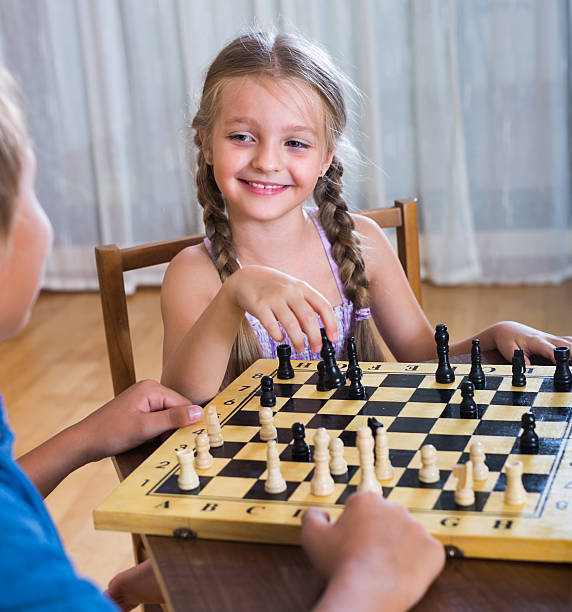 istock children at chess board indoors 589436826