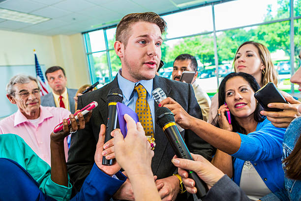 istock Concerned man answering questions from journalists 589437092