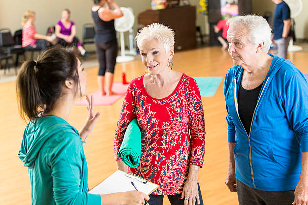 istock Yoga instructor registers senior couple for class 589437326