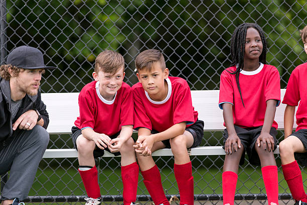 istock Soccer coach with his diverse childrens soccer team 589437572
