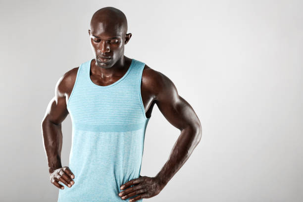 istock Masculine young african man over grey background 589437584