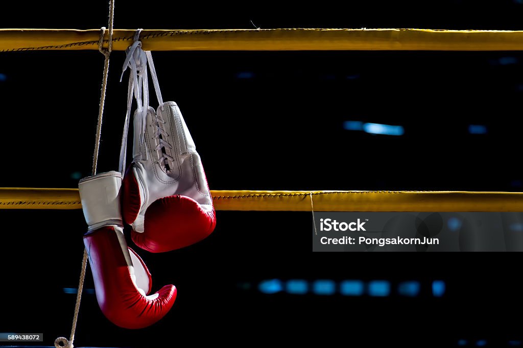 boxing gloves hangs off the boxing ring boxing gloves hangs off the boxing ring in a slum campboxing gloves hangs off the boxing ring in a slum camp Boxing - Sport Stock Photo