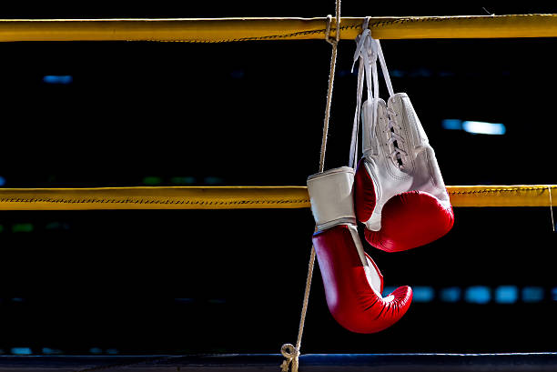 istock boxing gloves hangs off the boxing ring 589438172