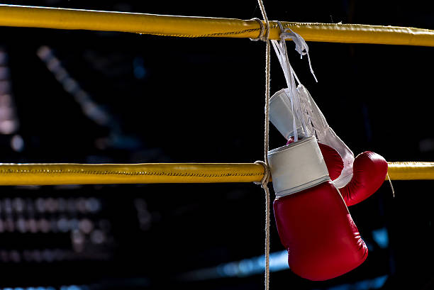 istock boxing gloves hangs off the boxing ring 589438286