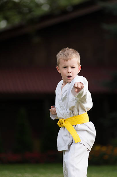 istock Karate Kid with yellow belt 589438362