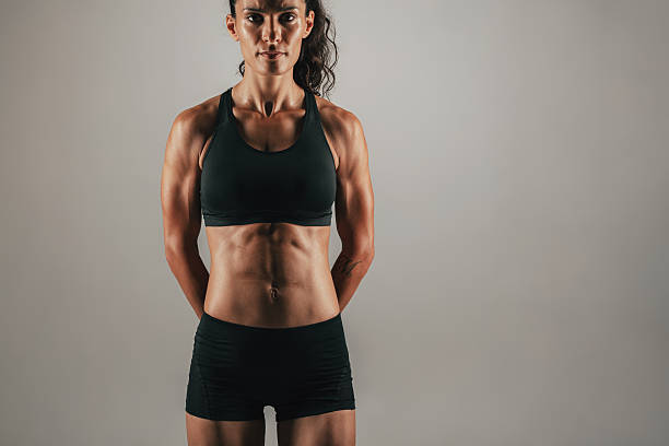istock Muscular woman with arms behind back 589440314