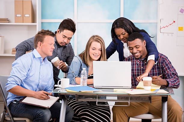 istock Creative young adult co-workers collaborate together. 589441142