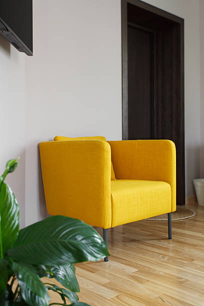 istock Yellow armchair near white wall 589441210
