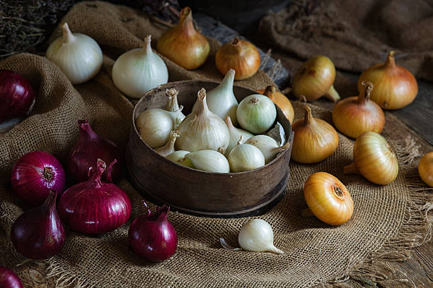 istock Yellow, red and white onions on a wooden surface 589443360