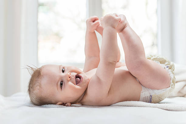 istock Cute baby girl smiling cheerfully 589443924