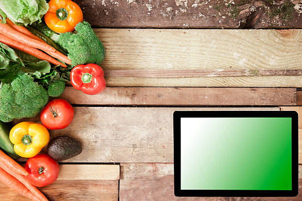istock Variation of organic vegetables with digital tablet. 589444140