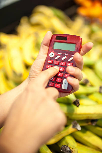 istock Using a calculator at the supermarket 589445120