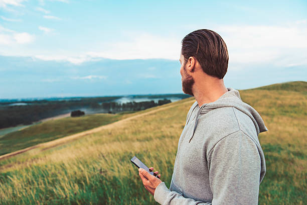 istock Runner takes a break with smart phone outside 589446502