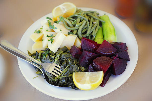 Salat With Marinated Beetroot Beans Potatoes Green Pepper Spinach Cook With Steam Fresh Lemon Fork And Spoon in The Plate on The Table
