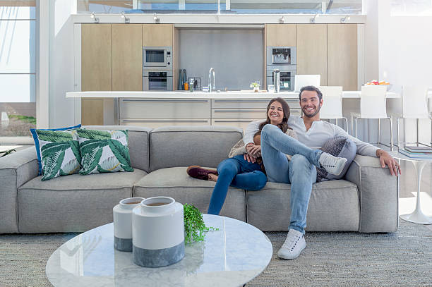 istock Couple sitting in a modern open plan house. 589448248