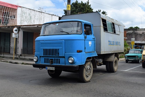 Santa Clara, Cuba - January 20th, 2016: IFA W50L in bus version driving on the street. The IFA was a conglomerate and a union of companies for vehicle construction in the former East Germany (DDR - Deutsche Demokratische Republik). The IFA W50L was the one of the most popular truck in Eastern Europe in 70s and 80s. Today we can see many of these trucks in Cuba.