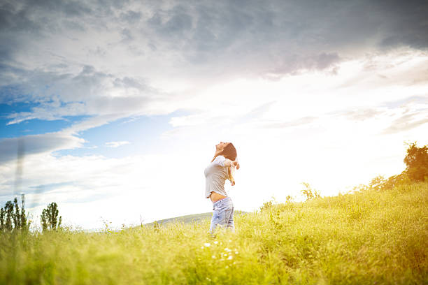 Girl in nature ,side view,holding hat
