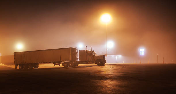 istock Foggy Midnight Interstate Expressway Rest Stop Parked Semi Trailer Truck 589451096