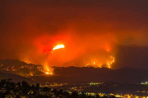 Night long exposure photograph of the Santa Clarita wildfire in CA. The Santa Clarita Valley mountains has drawn firefighters and emergency crews in the hills toward Acton. So far, the fire has burned 38,346 acres.
