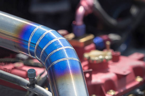 Mig welded stainless steel pipe in racing car Mig welded stainless steel intercooler pipe in racing car. tungsten metal stock pictures, royalty-free photos & images