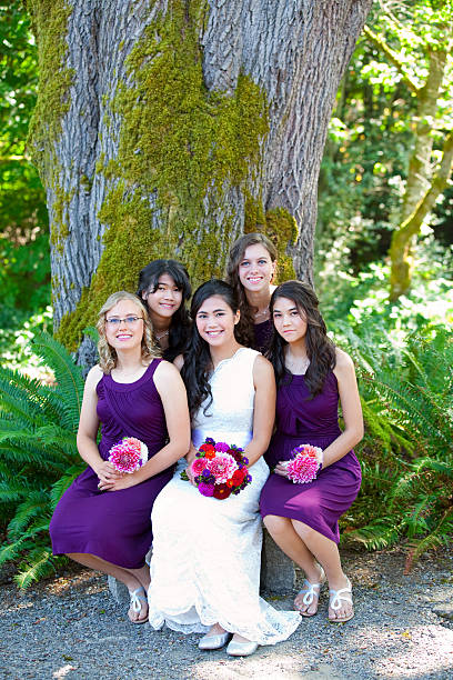 istock Beautiful biracial young bride smiling with multiethnic bridesmaids 589452530