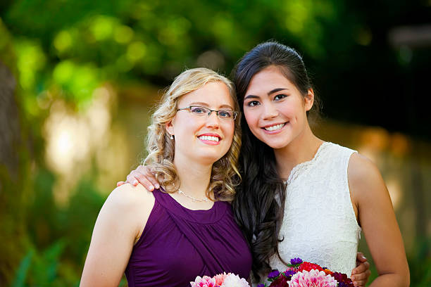 istock Beautiful biracial young bride smiling with bridesmaids 589452760