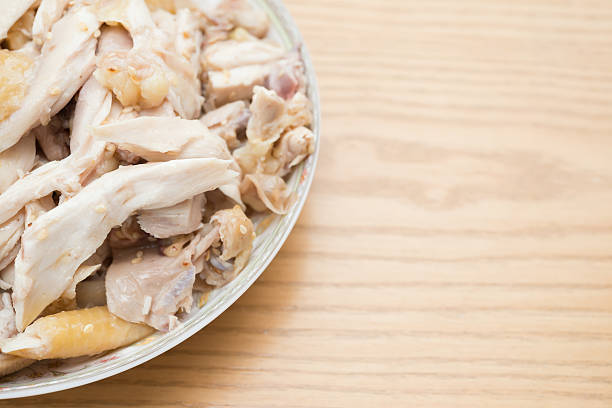 istock dish of shredded boiled chicken on wood table 589452878