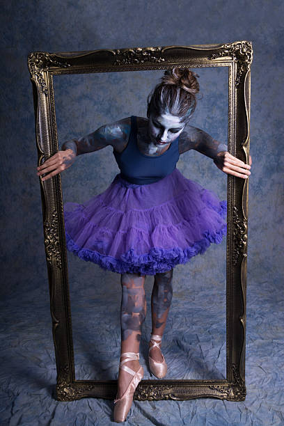 istock Ballet dancer in body and face paint stepping through frame 589453318