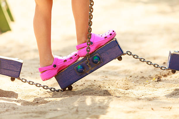 Time for fun. Summer holidays concept. Little funny girl having fun on playground. Child using kids equipment. Enjoyable playful kid outdoors.