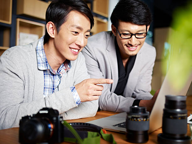 istock asian photographers at work 589456372