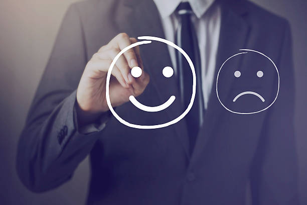 istock Customer choosing to write satisfied face over unhappy face 589456438