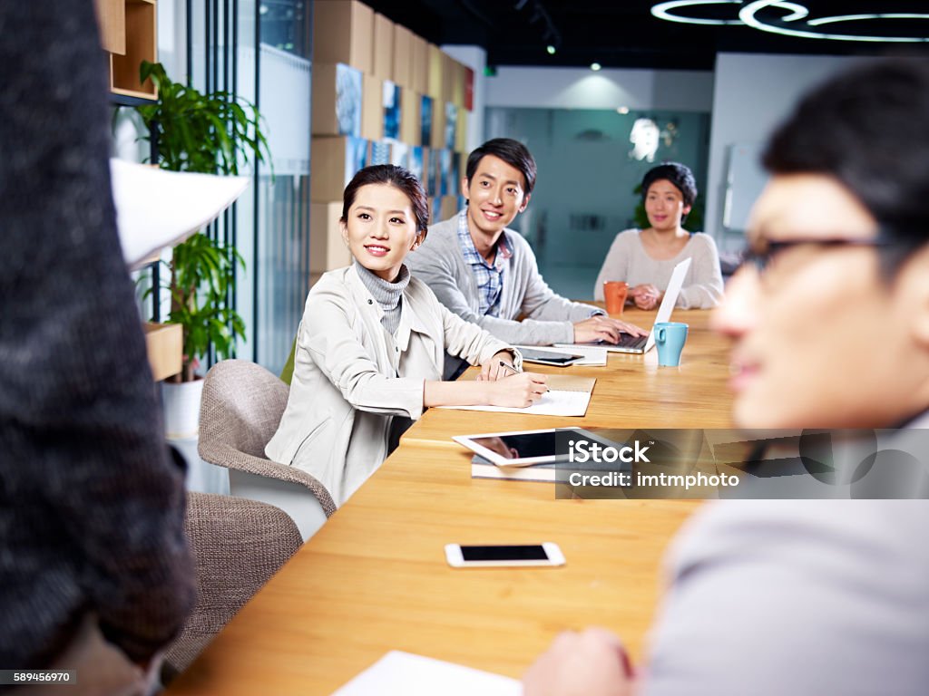 young asian businesspeople meeting in office a team of young asian entrepreneurs meeting in office discussing ideas for new business. Trainee Stock Photo