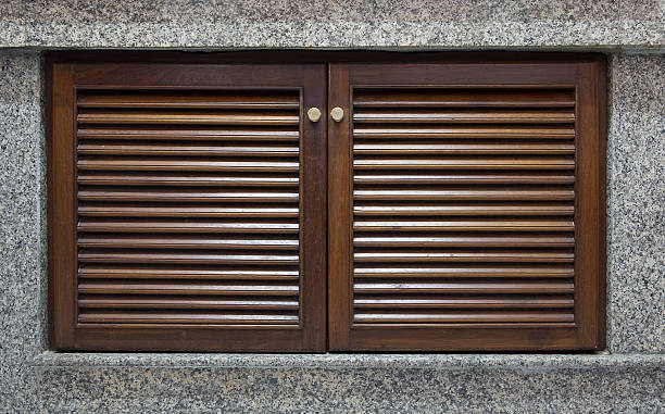 istock Wooden door and window shutter with louvers for background 589459142