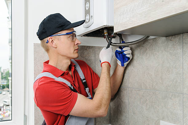 istock Plumber attaches to pipe gas boiler. 589459478