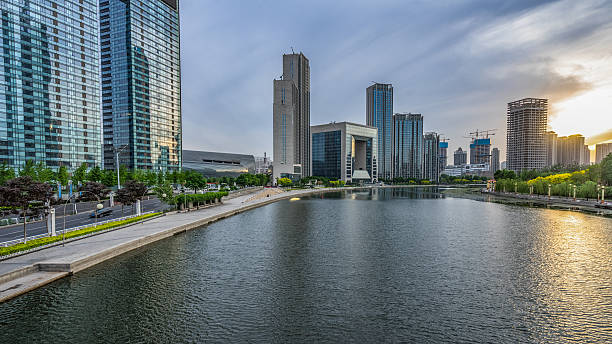 istock Modern buildings and river in urban city 589459624