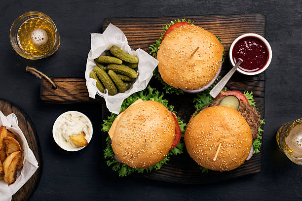istock Different burger with pickles, ketchup, mayonnaise, fries and li 589459630