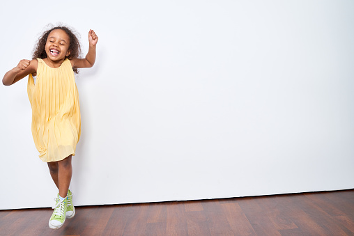 Little girl having fun at the wall