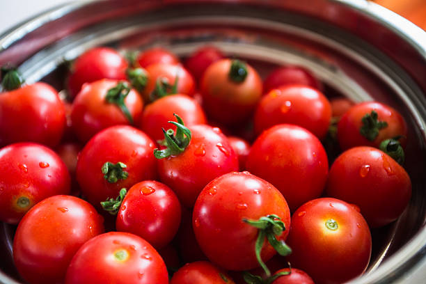 istock Red tomatoes background. Group of tomatoes in a plate 589538058