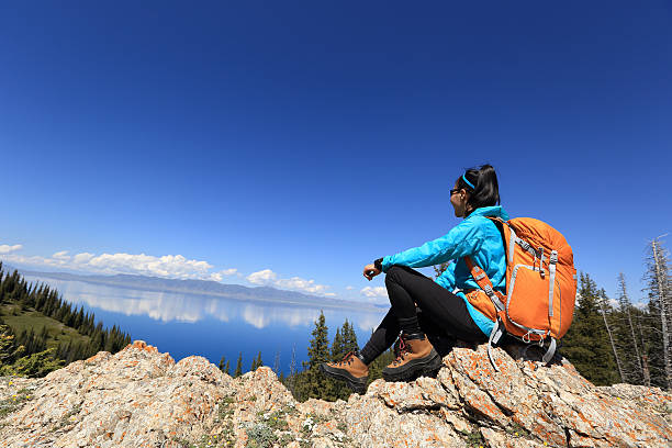 istock young woman backpacker hiking on beautiful mountain peak 589538452