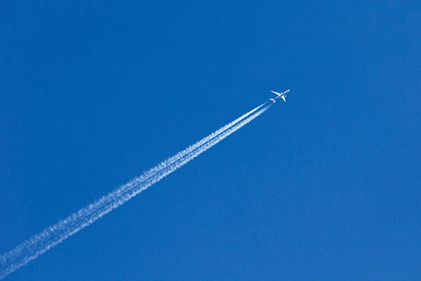 White airplane trace on blue sky Contrails over blue sky vapor trail photos stock pictures, royalty-free photos & images