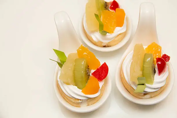 fresh fruit and cream cakeroll in spoon