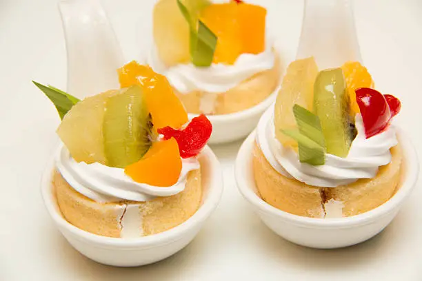 fresh fruit and cream cakeroll in spoon