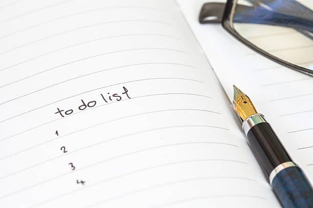 istock writing to do list on notebook page with pen 589544396