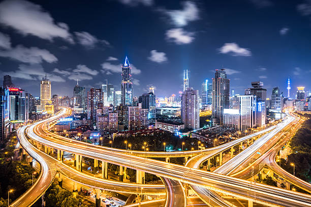 Shanghai Highway at Night Crowds of cars passing a road intersection in downtown Shanghai. night freeway stock pictures, royalty-free photos & images