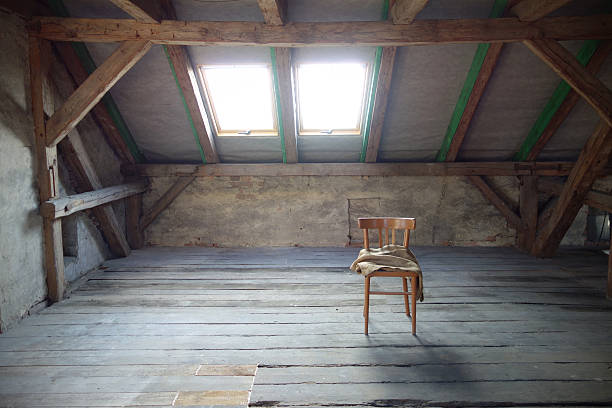 Attic with exposed beams and roof windows stock photo
