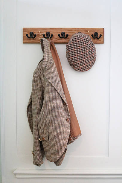 istock Tweed jacket and flat cap hanging on blue wall 589546962
