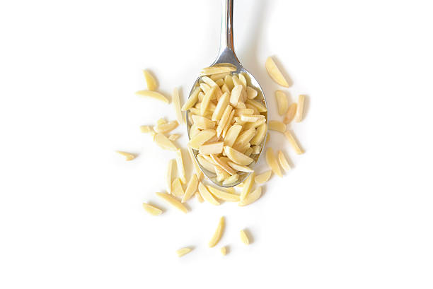 Almond chopped on white background - isolated Almond chopped on white background - isolated almond slivers stock pictures, royalty-free photos & images