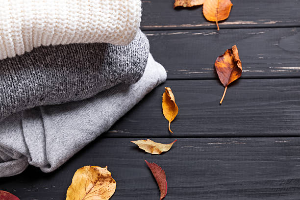 Cozy sweaters and autumn leaves