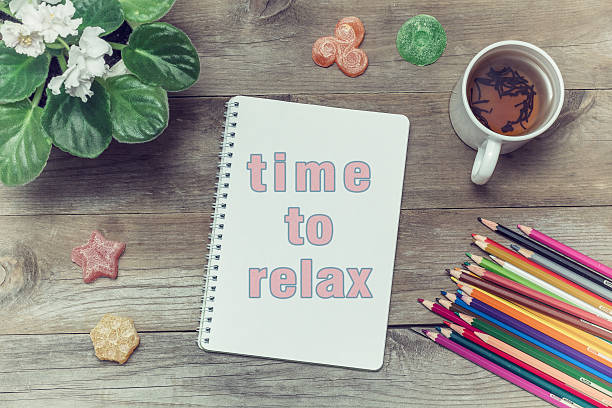 istock Tea with sweets and inscription in notebook: Time to relax 589548590