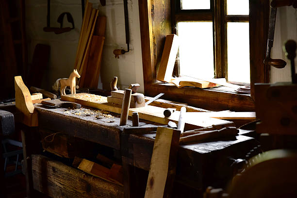 istock Vintage wooden drawing desk in carpenter workshop at window 589549216